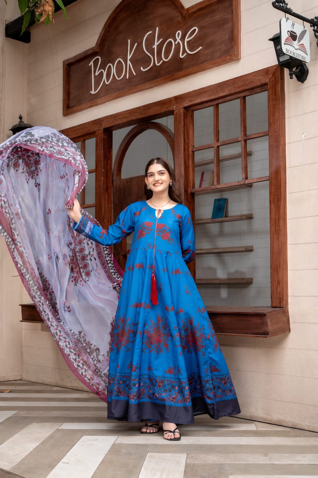  Model wearing royal blue printed 2 piece suit with flowing digital printed dupatta.
