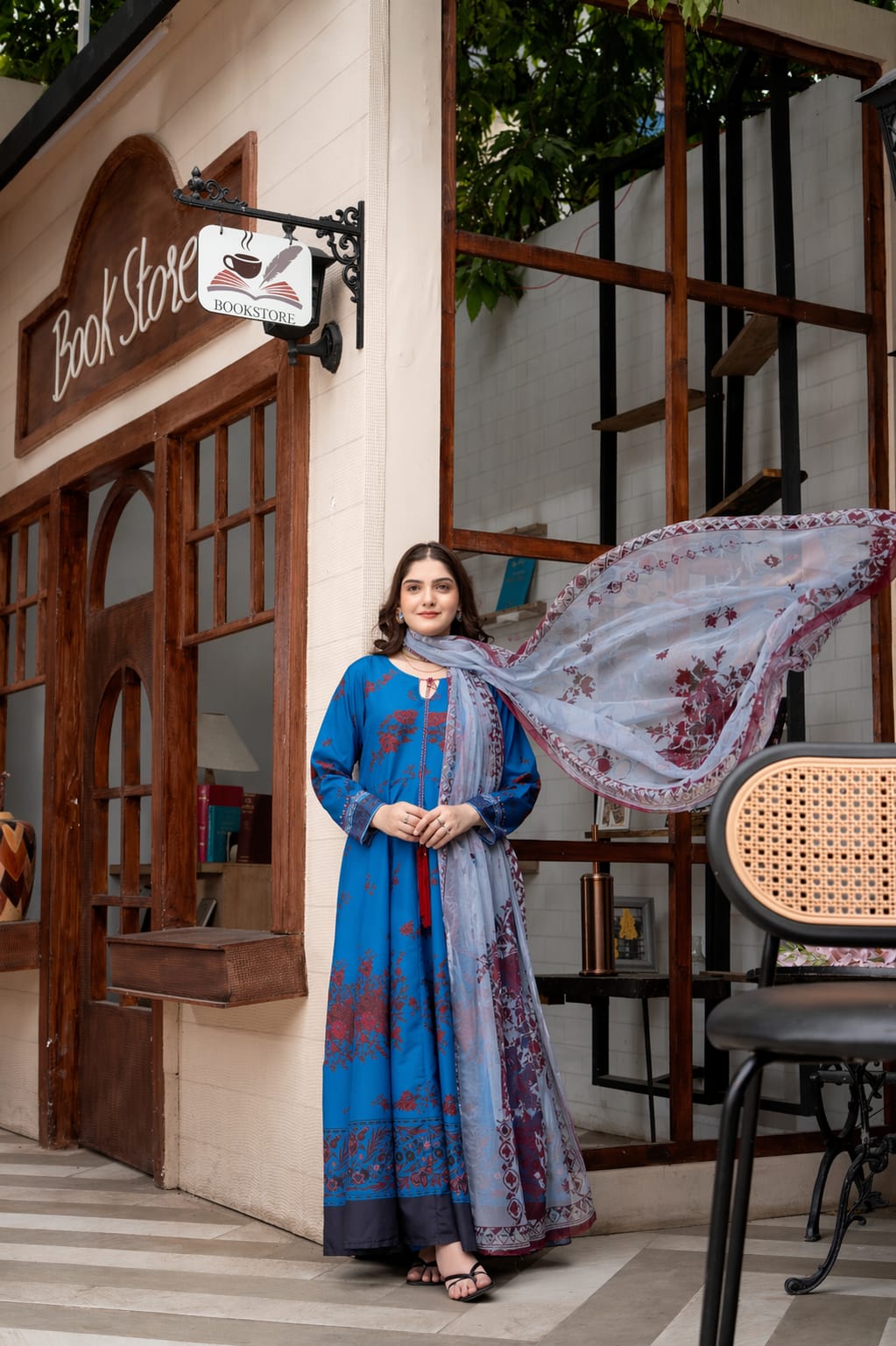  Close-up portrait of model wearing royal blue floral printed 2 piece suit and digital printed dupatta.
